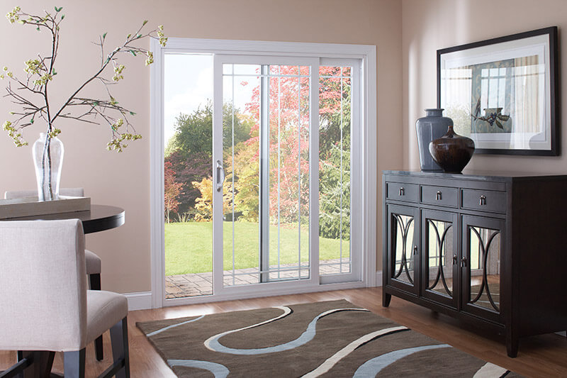 A sliding patio doors which leads from the backyard to a modern living room.