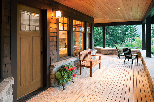 A large, brown front door with quarter glass insert