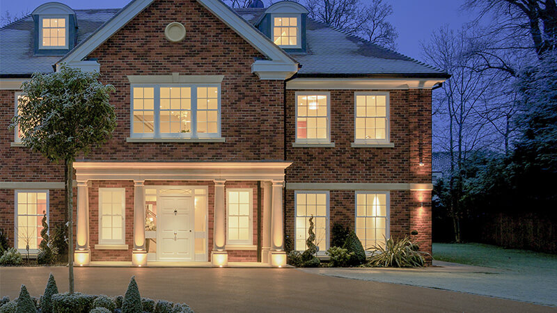 A large home with huge windows and a modern front door.