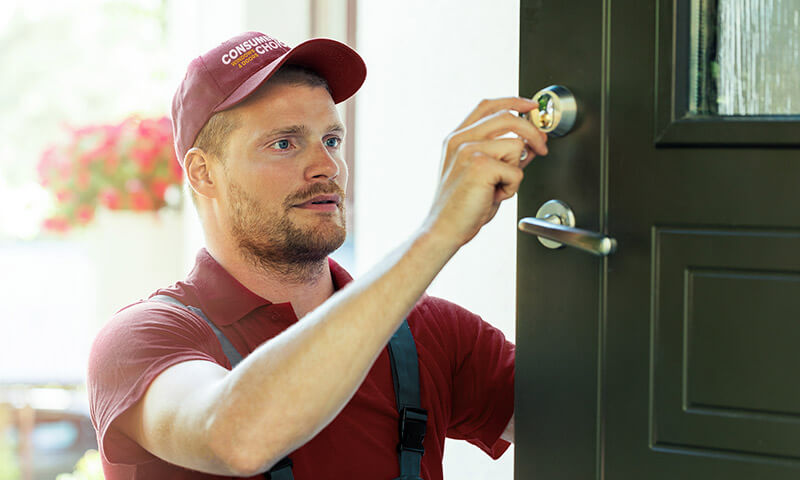 A Consumer's Choice front door installer puts in a new lock for a brand new residential steel entry door.