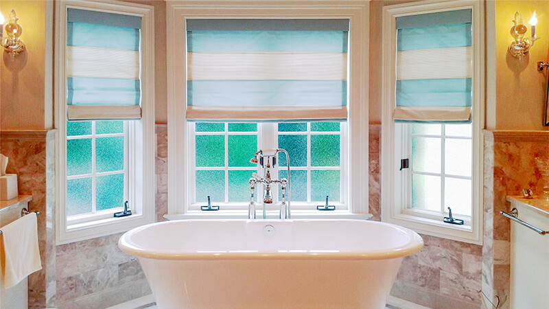 Three replacement casement windows over a gorgeous, modern bathtub.